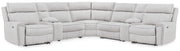 Signature Design by Ashley reclining sectional sofa with plush cushions and reclining features, showcasing a modern living room setup.