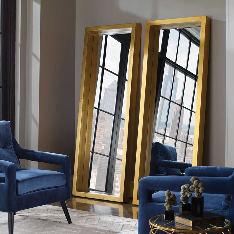 Gold Edmonton Leaner Floor Mirror by Uttermost with a sleek, modern frame reflecting in a stylish interior setting.