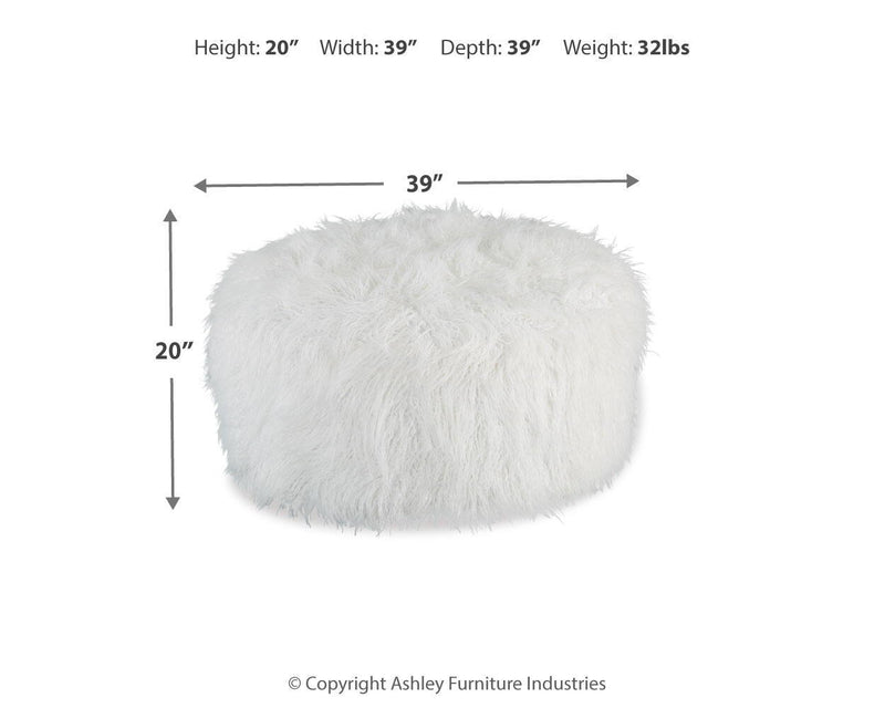 Large Signature Design by Ashley Galice oversized ottoman in neutral fabric, serving as a stylish accent piece.
