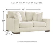 Signature Design by Ashley Maggie stationary loveseat with plush upholstery and sleek design, perfect for cozy living spaces.