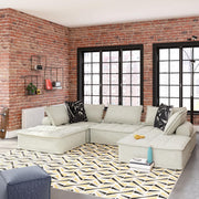Signature Design by Ashley stationary sectional sofa with plush cushions and modern design, shown in a living room setting.