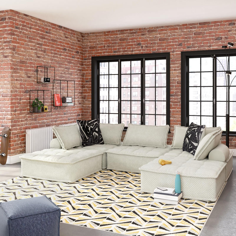 Signature Design by Ashley stationary sectional sofa with plush cushions and modern design, shown in a living room setting.