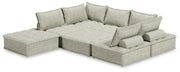 Signature Design by Ashley stationary sectional sofa with plush cushions and modern design, shown in a spacious living room.