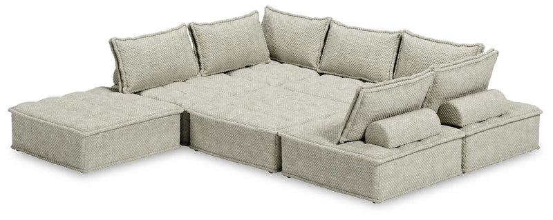 Signature Design by Ashley stationary sectional sofa with plush cushions and modern design, shown in a spacious living room.