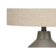 Contemporary 8th Street concrete table lamp with a sleek, minimalist design and a neutral finish on a wooden surface.