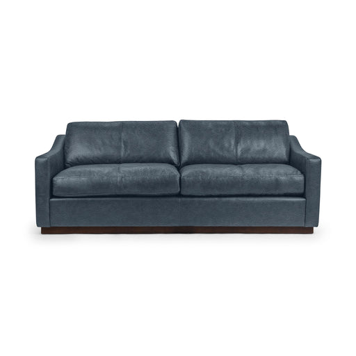 Classic Home Aspen stationary sofa with plush beige upholstery and rolled arms in a cozy living room setting.