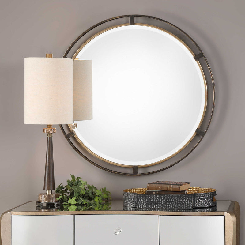 Uttermost Carrizo round bronze wall mirror with a sleek, modern frame and reflective glass, ideal for contemporary home decor.