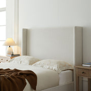 House & Home Furniture Hosford minimalist upholstered wingback bed with wood platform base, showcasing clean lines and padded headboard.