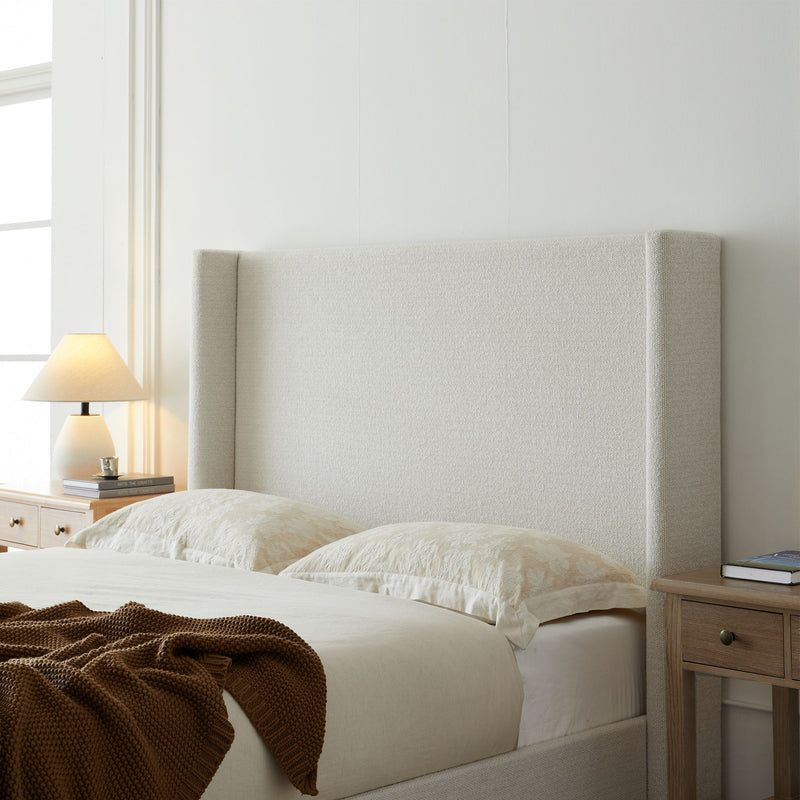 House & Home Furniture Hosford minimalist upholstered wingback bed with wood platform base, showcasing clean lines and padded headboard.
