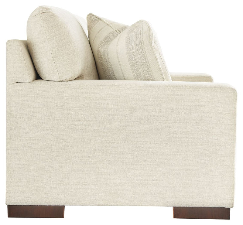 Signature Design by Ashley Maggie stationary loveseat with plush fabric and cozy cushions, perfect for living room seating.
