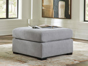 Benchcraft Lakepoint oversized accent ottoman with a nickel finish, featuring a plush upholstered top and modern design.