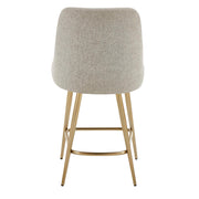 Gray upholstered counter stool with gold accents, featuring a modern design and wooden legs, perfect for kitchen or bar area.