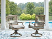 Pair of Signature Design by Ashley Rainier Ranch swivel chairs with beige cushions, brown wood finish, and comfortable seating.