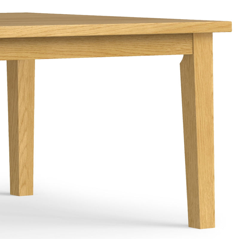 Simpli-Home handcrafted dining table with a wooden surface and sturdy legs, ideal for family meals and gatherings.