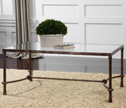 Uttermost Warring iron coffee table with a rustic, industrial design featuring a sturdy metal frame and wooden tabletop.