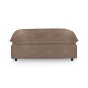 Classic Home Caplan upholstered ottoman with plush fabric and wooden legs, ideal as a stylish living room accent piece.