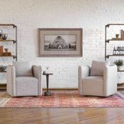 Uttermost Corben swivel chair with beige fabric upholstery and dark wooden legs, featuring a modern ergonomic design.