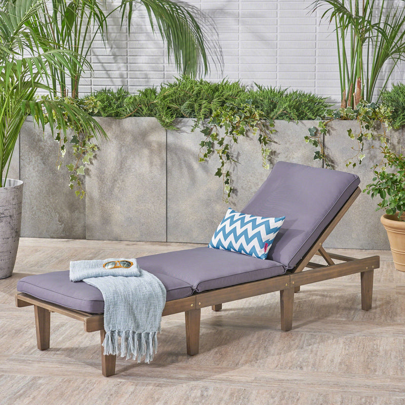 Noble House Ariana wood chaise lounge with cushion, featuring a sleek design and comfortable seating for relaxing indoors or outdoors.