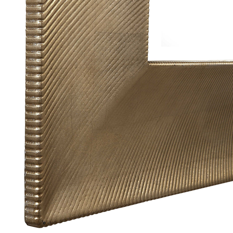 Uttermost Valenton large wall mirror with champagne-colored frame, elegant modern design, and beveled glass.