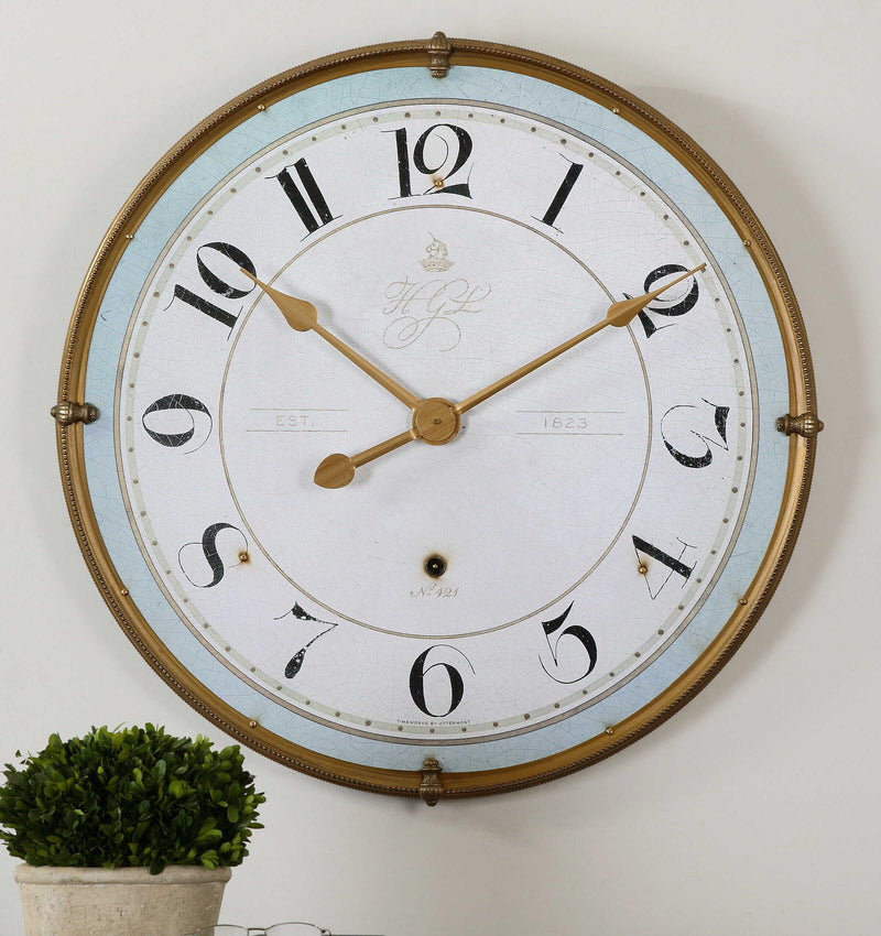 Uttermost Torriana gold wall clock with a round face and minimalist design, perfect for modern home decor.
