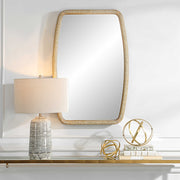 Gold Tiki accent mirror by Uttermost featuring a sleek, modern design with a polished gold finish and a stylish tiki-shaped frame.