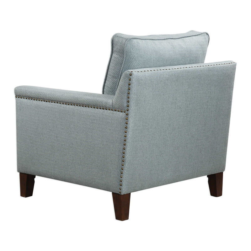 Uttermost Charlotta Accent Chair in Sea Mist fabric with plush cushioning and wooden legs, stylish arm chair for living spaces.