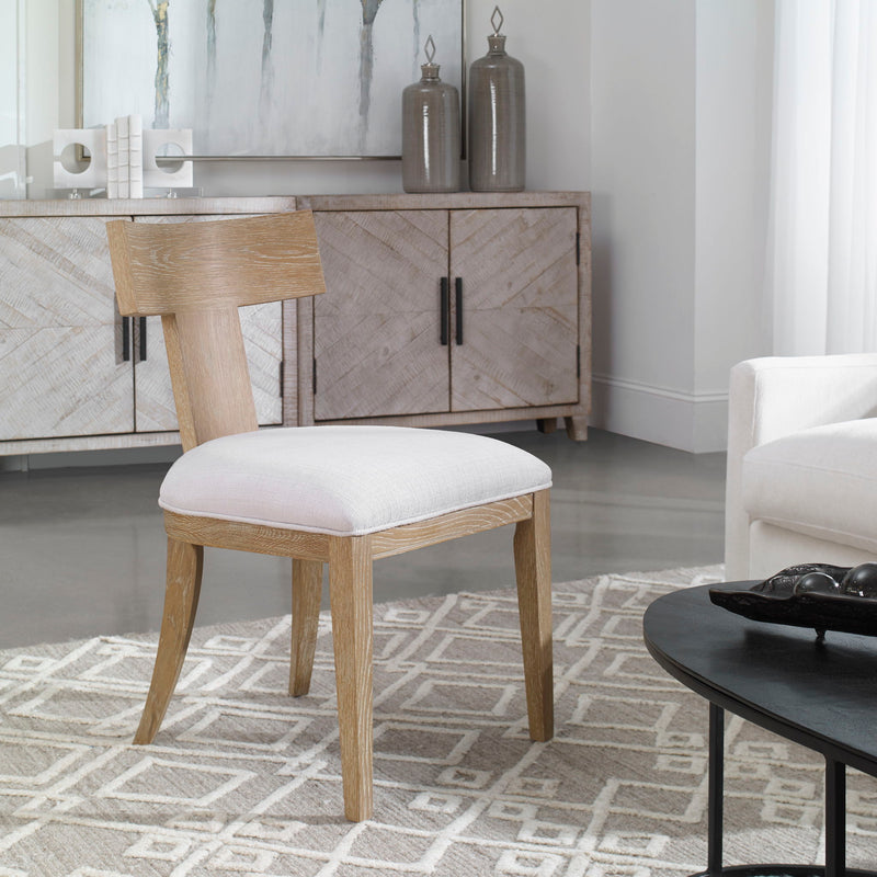 Uttermost Idris armless side chair with plush fabric upholstery and modern design, shown from a front view.