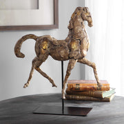 Gold Uttermost Caballo horse sculpture, detailed figurine with a shiny gold finish, decorative sculpture for home decor.