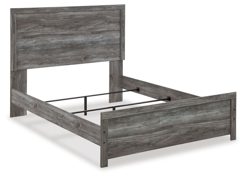 Signature Design by Ashley Bronyan Panel Bed with wooden frame and panel headboard, shown in a modern bedroom setting.