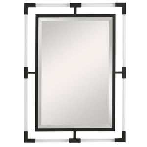 Uttermost Balkan iron wall mirror with round frame, decorative metal design, hanging on a neutral wall interior.