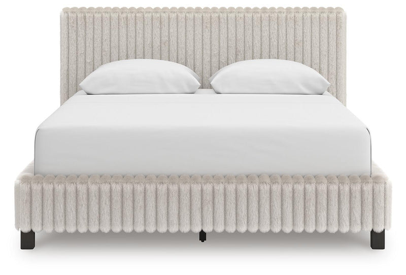 Signature Design by Ashley Zuraleus upholstered bed with a padded headboard and neutral fabric, showcasing a modern bedroom style.