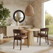Vina vegan leather dining arm chair by TOV Furniture with sleek modern design and cushioned seat in a contemporary setting.