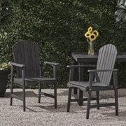 Set of two Noble House outdoor weather-resistant acacia wood Adirondack dining chairs on patio.