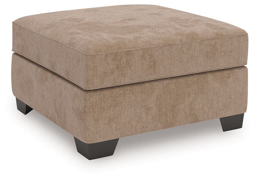 Olten Benchcraft® accent ottoman with plush fabric and wooden legs, serving as versatile living room furniture.