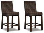 Set of two Signature Design by Ashley Paradise Trail barstools in medium brown wood with cushioned seats, modern and stylish for dining.