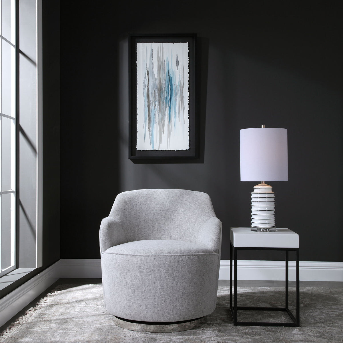 Gray Hobart casual swivel chair by Uttermost featuring a modern design with a rounded back and cushioned seat.