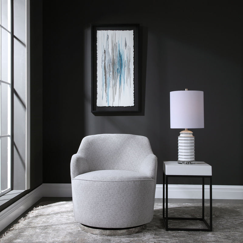 Gray Hobart casual swivel chair by Uttermost featuring a modern design with a rounded back and cushioned seat.