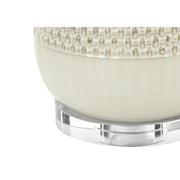 Cream ceramic and resin contemporary 8th Street table lamp with a sleek, modern design and soft lighting.