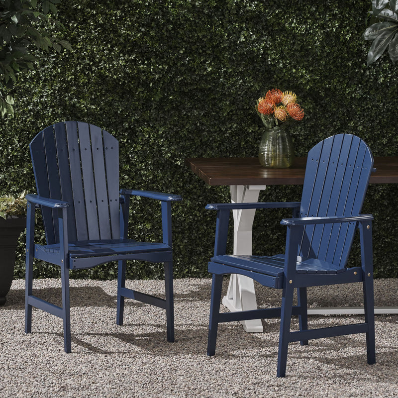 Set of two Noble House outdoor weather-resistant acacia wood Adirondack dining chairs with wide armrests and slatted backs.