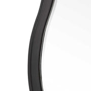 Uttermost Aneta round wall mirror with a sleek modern frame, hanging on a wall, showcasing its reflective glass surface.