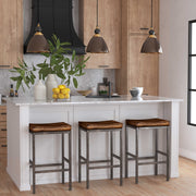 Uttermost Adastra 1-light pendant in antique brass with sleek, modern design, hanging from a black cord with a clear glass shade.