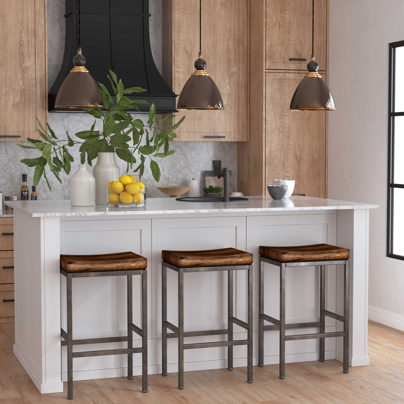 Uttermost Adastra 1-light pendant in antique brass with sleek, modern design, hanging from a black cord with a clear glass shade.