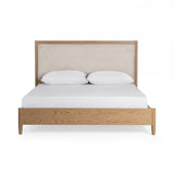 Upholstered bed in neutral fabric with a padded headboard by Classic Home, styled in a modern bedroom setting.