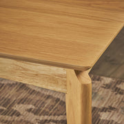 Mid century dining table by Noble House with rubberwood and walnut veneer, showcasing natural oak finish and sleek design.