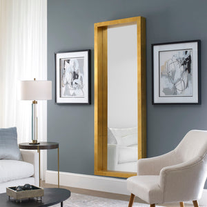 Gold Edmonton Leaner Mirror by Uttermost, floor mirror with a sleek, modern design and a polished gold frame.