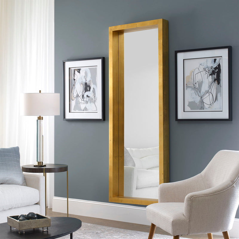 Gold Edmonton Leaner Mirror by Uttermost, floor mirror with a sleek, modern design and a polished gold frame.