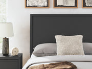 Danziar panel bed with low footboard by Signature Design Ashley, showing the wooden bed frame and clean, modern design