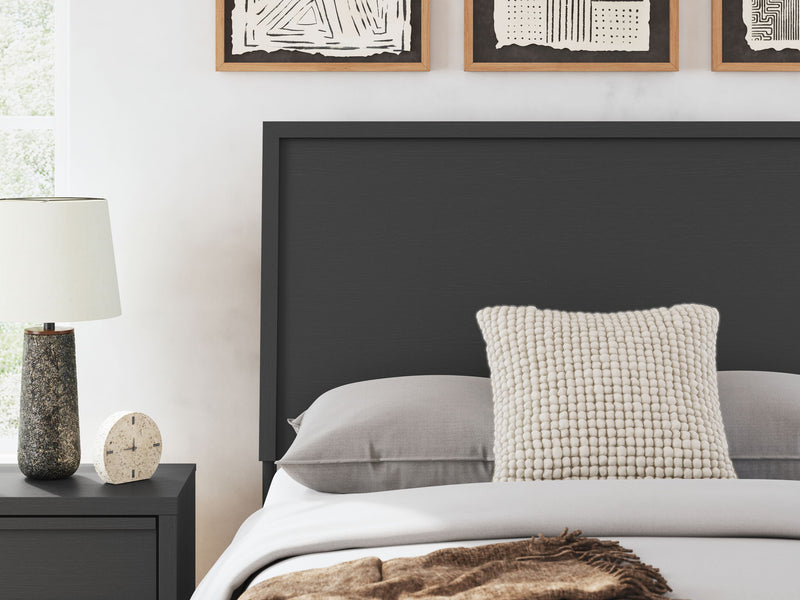 Danziar panel bed with low footboard by Signature Design Ashley, showing the wooden bed frame and clean, modern design