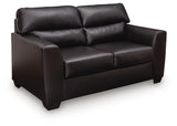 Midnight Glennbre stationary loveseat by Signature Design by Ashley® with plush cushions and modern design, shown in a cozy living room setting.