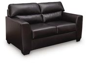 Midnight Glennbre stationary loveseat by Signature Design by Ashley® with plush cushions and modern design, shown in a cozy living room setting.